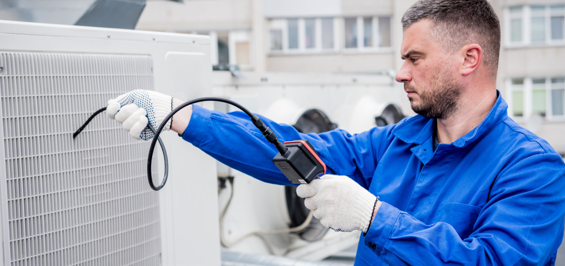 The technician uses a digital camera to check the clogging of the heat exchanger