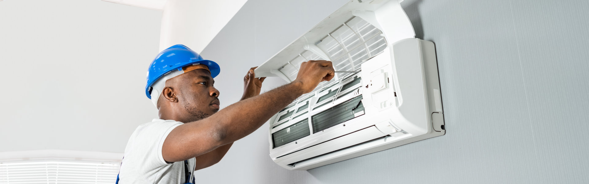 Technician Repairing Air Conditioner